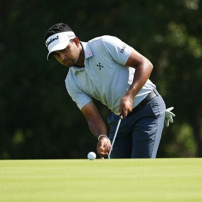 Golfer focusing on putting green, demonstrating mental focus